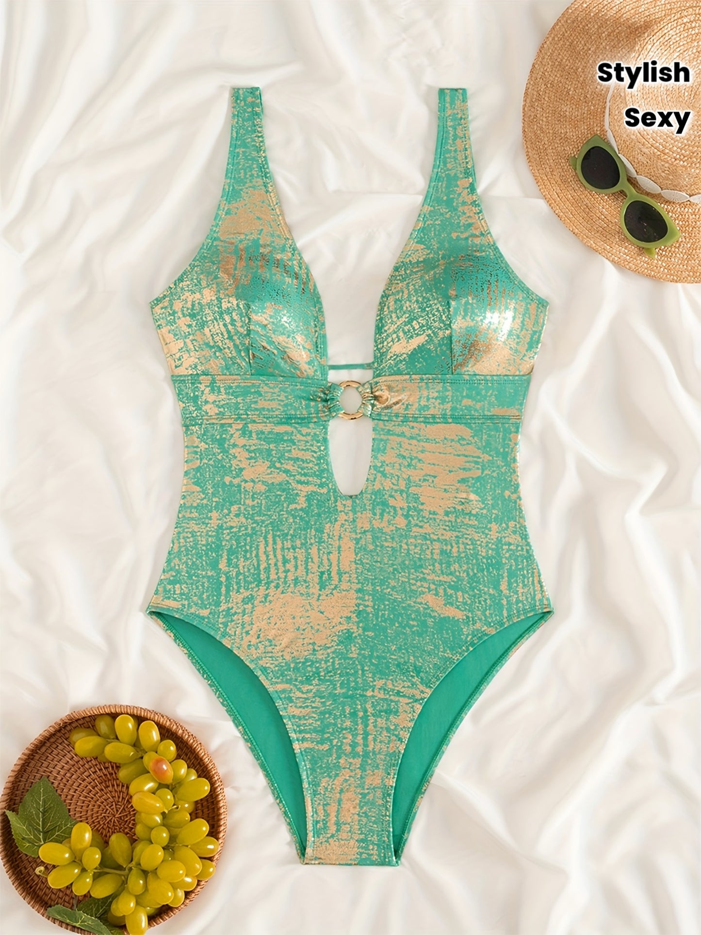 Trendy swimsuit in shiny fabric with a sexy deep V-neck and a bare back with a bow.